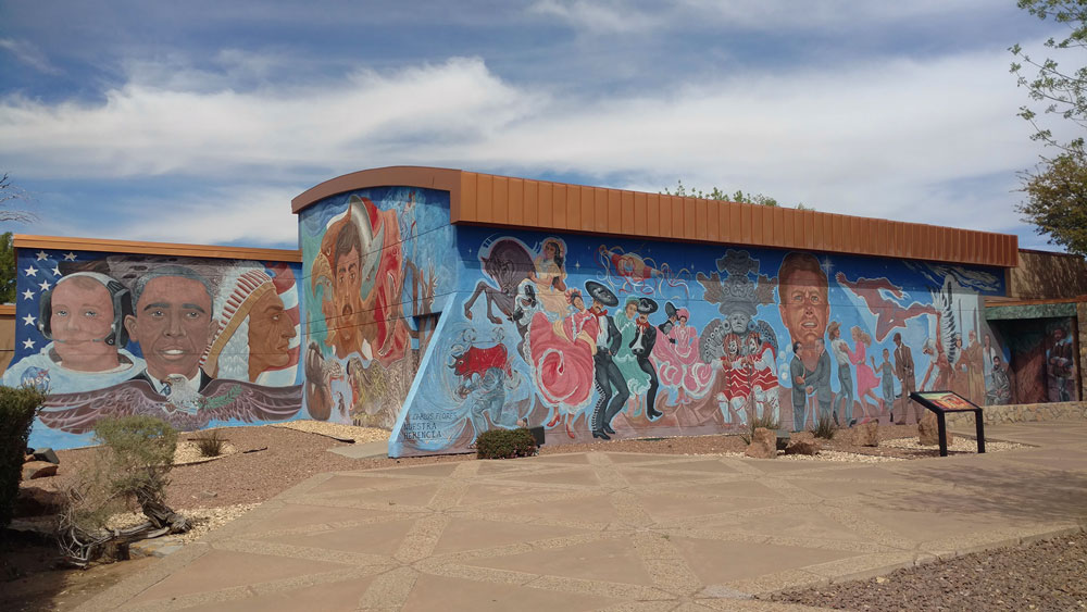 A colorful mural depicting some of the diverse people, history, and heritage of the United States and Mexico